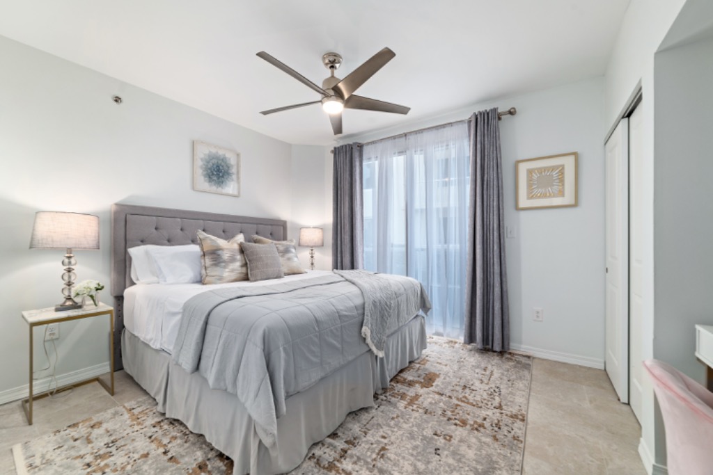 Second bedroom with king bed and ceiling fan
